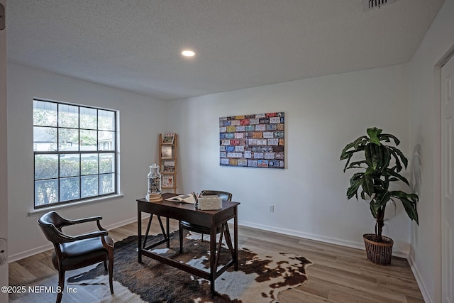 office area featuring hardwood / wood-style floors and a textured ceiling