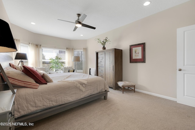 bedroom with ceiling fan and light carpet