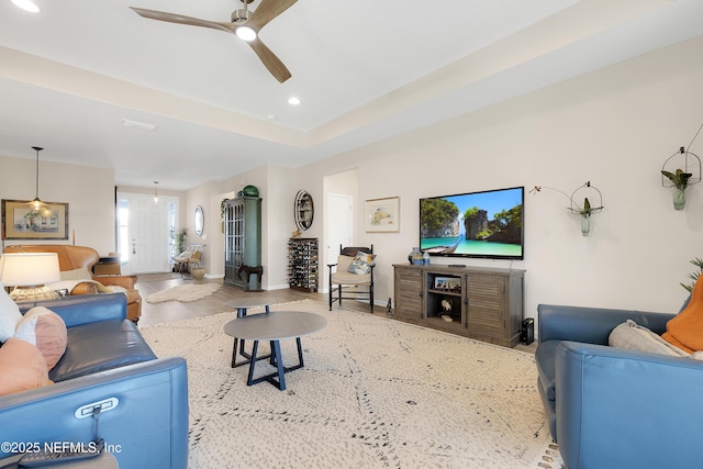 living room with ceiling fan and light wood-type flooring