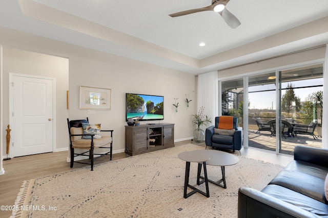 living room with ceiling fan and light hardwood / wood-style floors