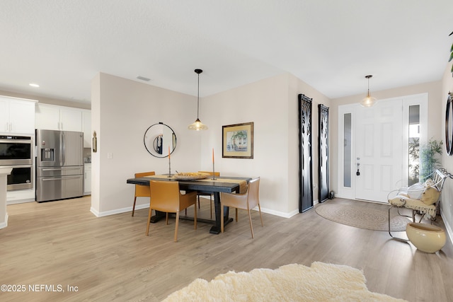 dining area with light wood-type flooring