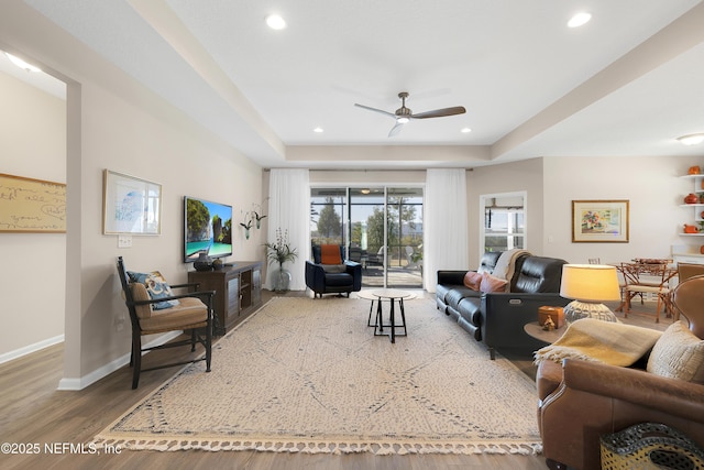 living room with hardwood / wood-style flooring and ceiling fan