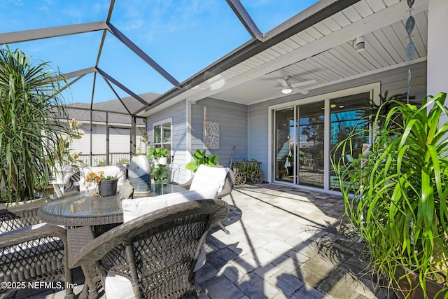 view of patio / terrace with ceiling fan and glass enclosure