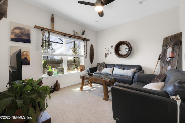 carpeted living room with ceiling fan