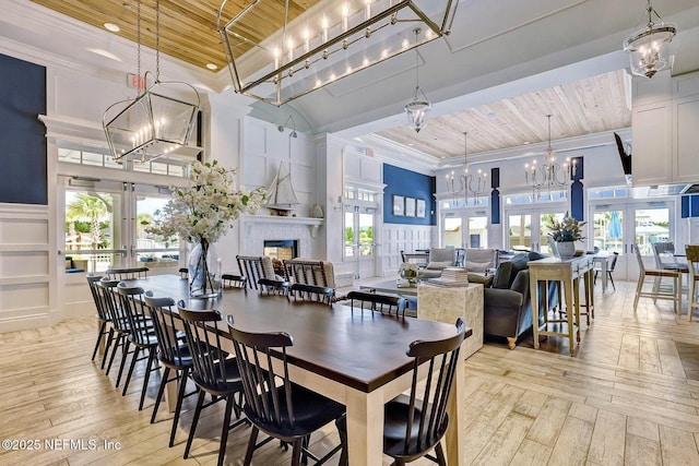 dining space featuring french doors, wood ceiling, and a chandelier