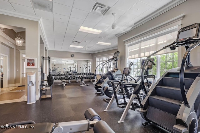 exercise room featuring a drop ceiling and ornamental molding