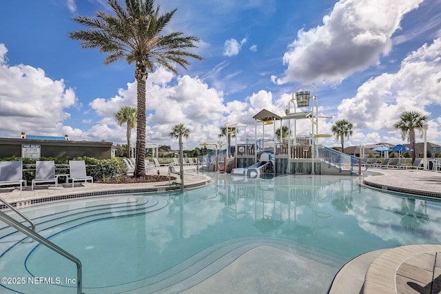 view of swimming pool with a water slide