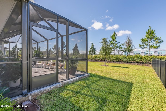 view of yard with a patio and glass enclosure