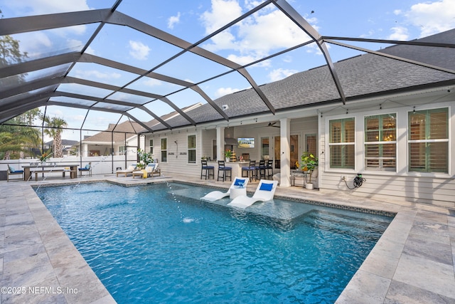 view of swimming pool with a lanai, a patio area, and pool water feature