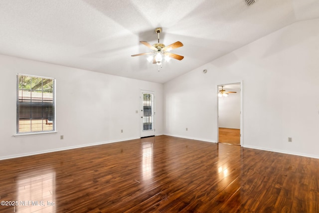 unfurnished room with ceiling fan, lofted ceiling, dark hardwood / wood-style flooring, and a textured ceiling