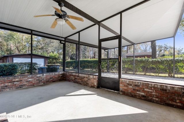 unfurnished sunroom featuring ceiling fan