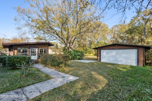 view of yard with a garage and an outdoor structure