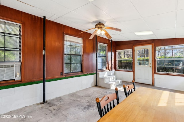 unfurnished sunroom featuring cooling unit and ceiling fan