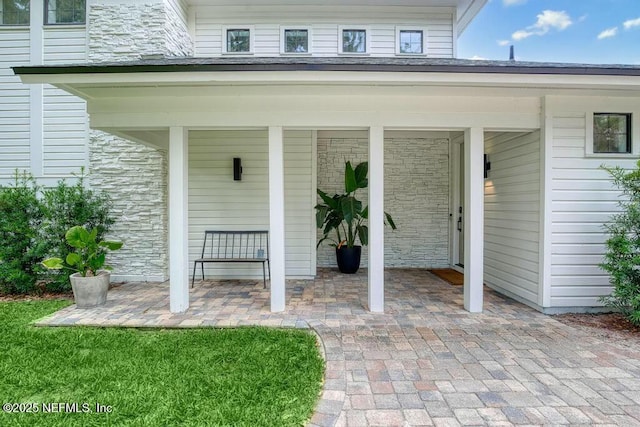 view of exterior entry featuring stone siding