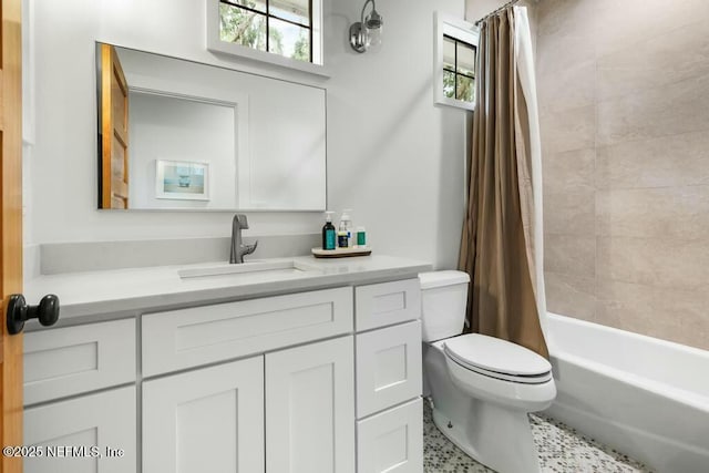 bathroom featuring vanity, toilet, and shower / bath combo with shower curtain