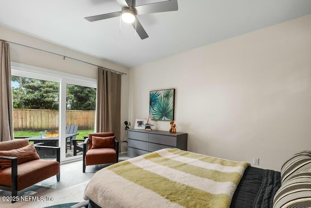 bedroom featuring finished concrete flooring, ceiling fan, and access to exterior