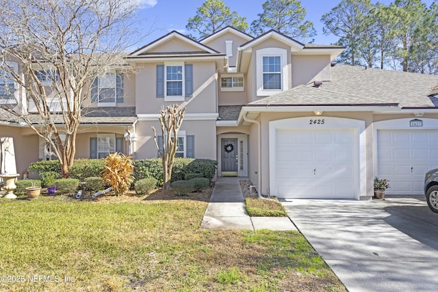 multi unit property with a garage and a front lawn