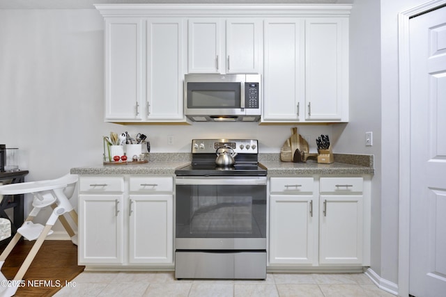 kitchen featuring white cabinetry and appliances with stainless steel finishes