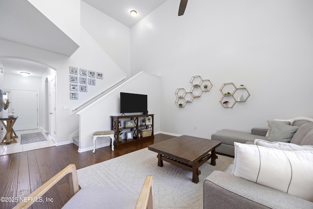 living room featuring hardwood / wood-style flooring and a high ceiling