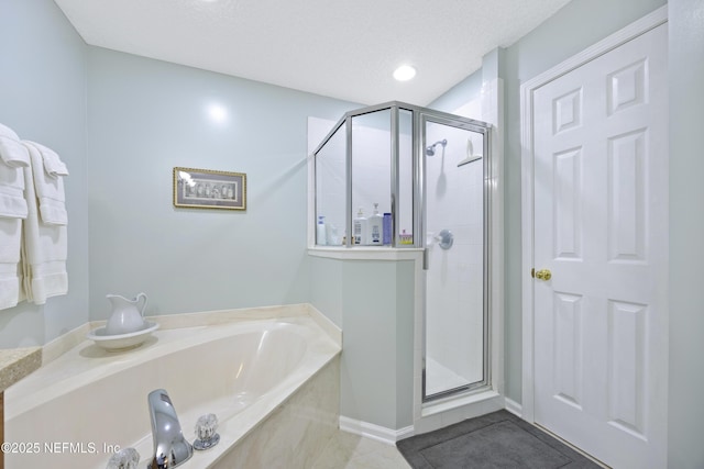 bathroom featuring tile patterned flooring, plus walk in shower, and a textured ceiling