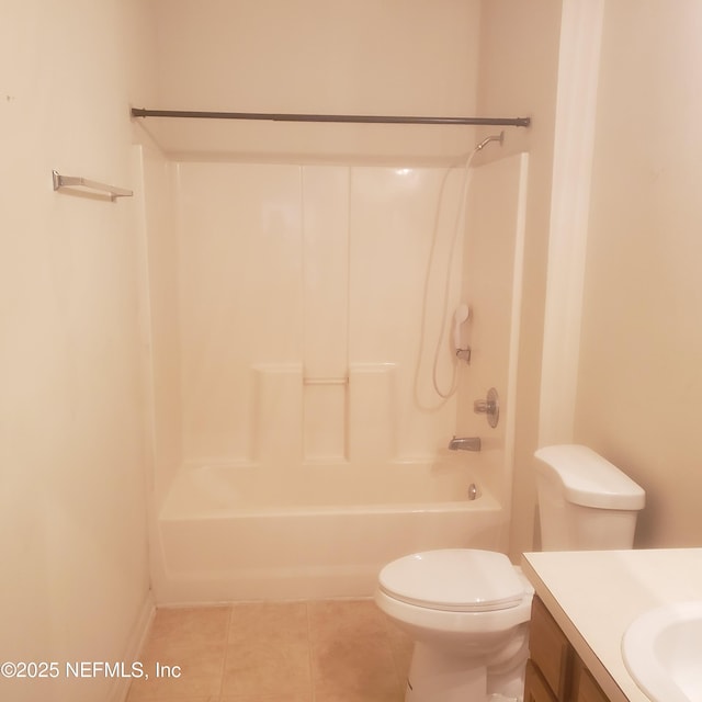 bathroom featuring toilet, tile patterned flooring, shower / washtub combination, and vanity