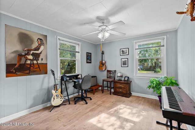 home office with ornamental molding, ceiling fan, and light hardwood / wood-style floors