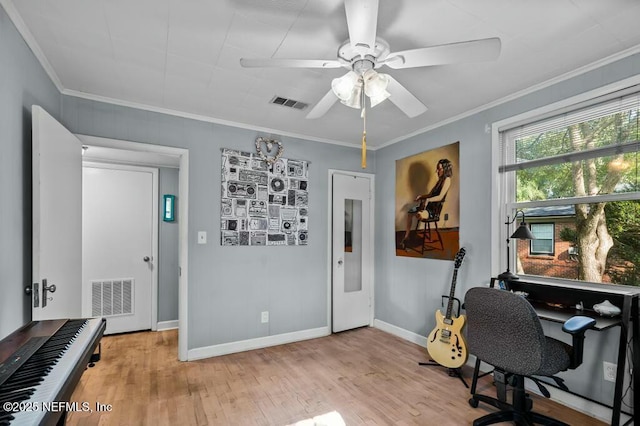 office space with ornamental molding, ceiling fan, and light hardwood / wood-style floors