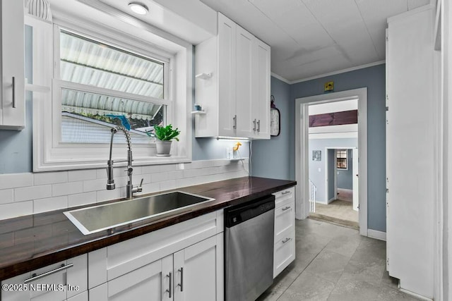 kitchen featuring white cabinetry, sink, crown molding, and stainless steel dishwasher