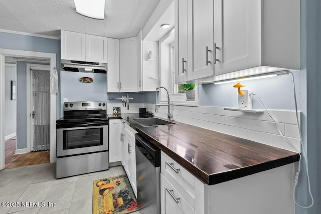 kitchen with stainless steel appliances, white cabinetry, sink, and ornamental molding