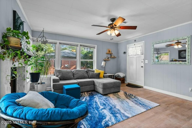 living room featuring hardwood / wood-style flooring, ceiling fan, and crown molding