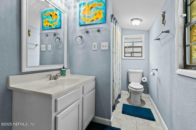 bathroom with tile patterned flooring, vanity, a wealth of natural light, and toilet