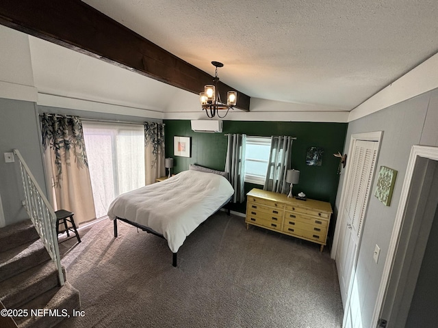 bedroom featuring a wall mounted air conditioner, lofted ceiling with beams, dark carpet, a textured ceiling, and an inviting chandelier