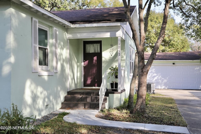 property entrance featuring a garage and central AC unit