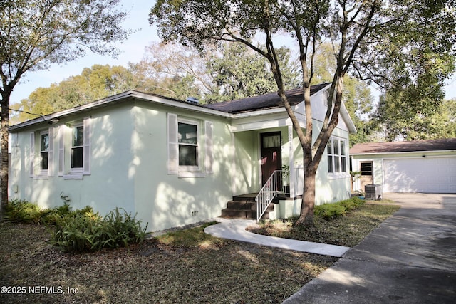 bungalow-style house with central AC and a garage