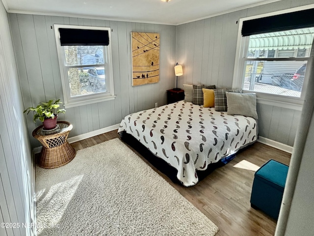 bedroom with wood-type flooring and ornamental molding