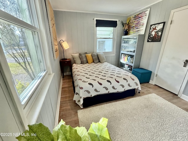 bedroom with crown molding and light hardwood / wood-style flooring