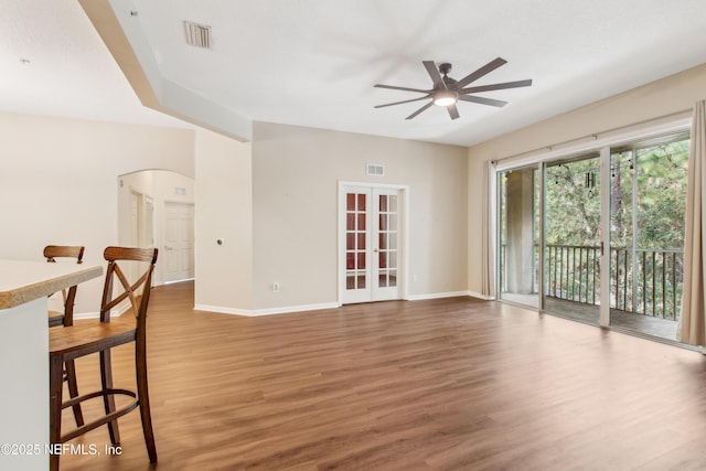 interior space with french doors, ceiling fan, and wood-type flooring