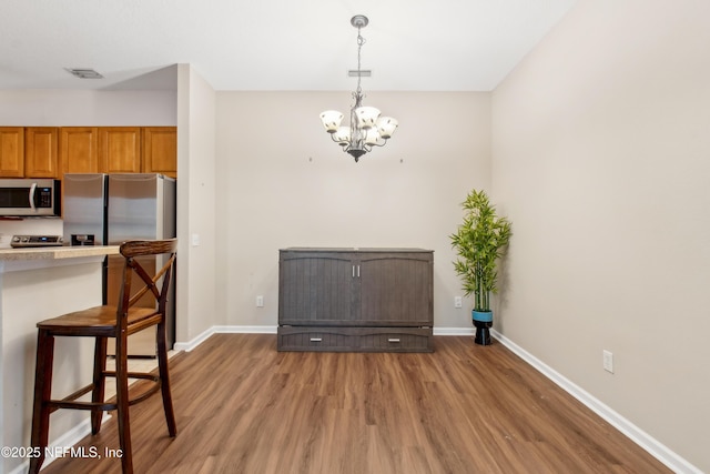 interior space featuring hardwood / wood-style floors and a notable chandelier