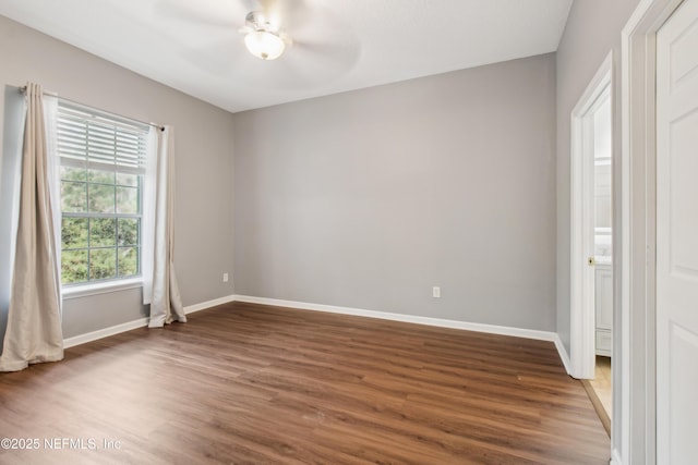 unfurnished room with ceiling fan and dark hardwood / wood-style floors