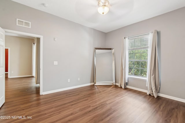 empty room featuring dark wood-type flooring