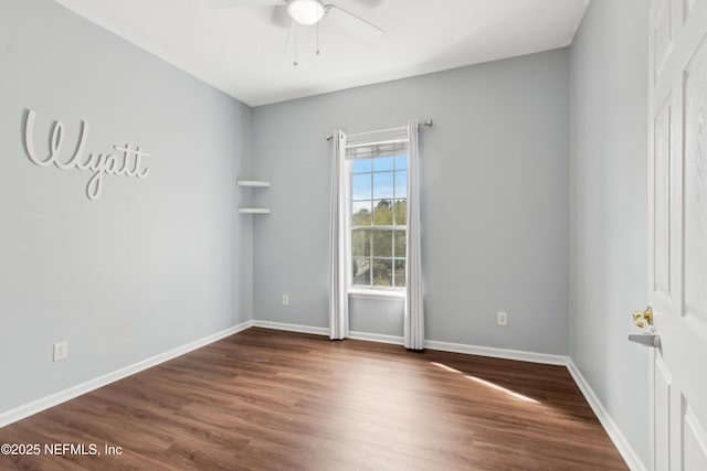 spare room with dark hardwood / wood-style floors and ceiling fan