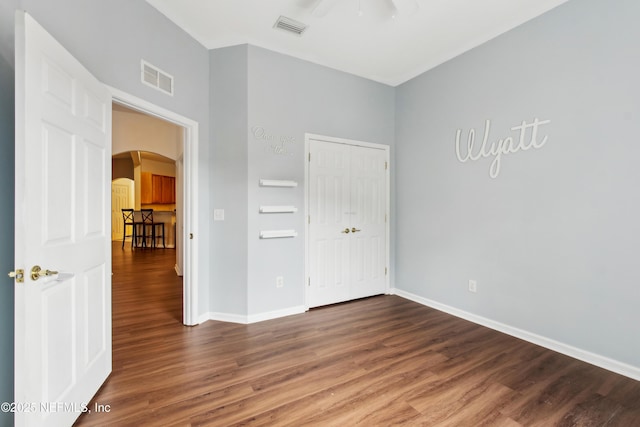 unfurnished bedroom with dark hardwood / wood-style floors and ceiling fan