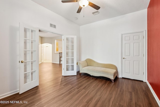 living area featuring french doors, lofted ceiling, and dark hardwood / wood-style flooring