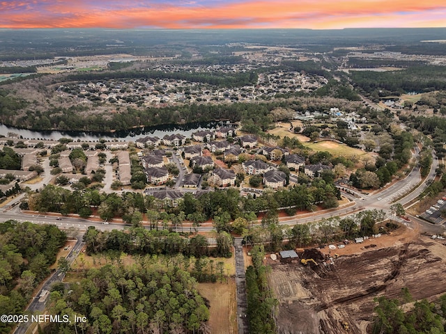 aerial view at dusk with a water view