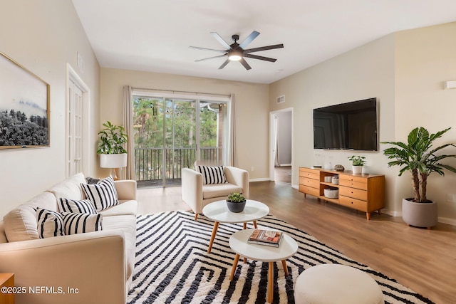 living room with hardwood / wood-style flooring and ceiling fan