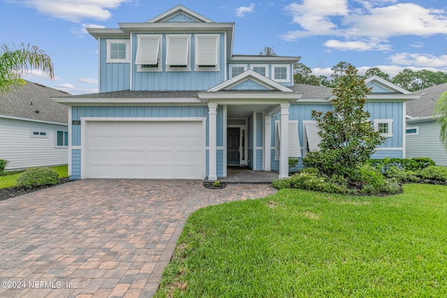 view of front facade with a garage and a front yard