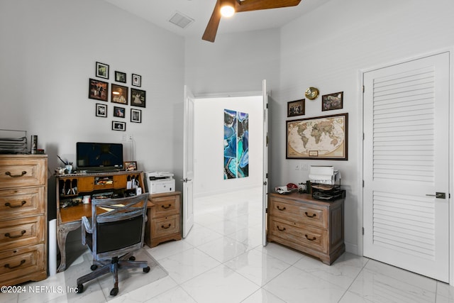 home office featuring a towering ceiling and ceiling fan