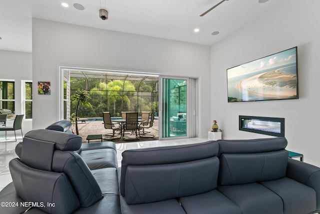 living room with a wealth of natural light and ceiling fan