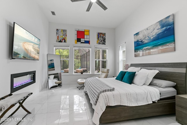 bedroom with a high ceiling and ceiling fan