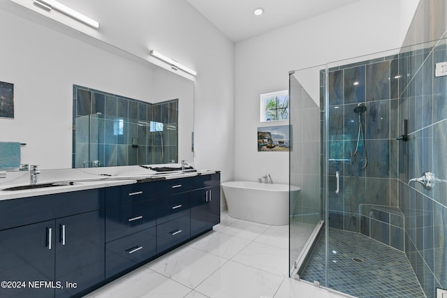 bathroom featuring vanity and independent shower and bath